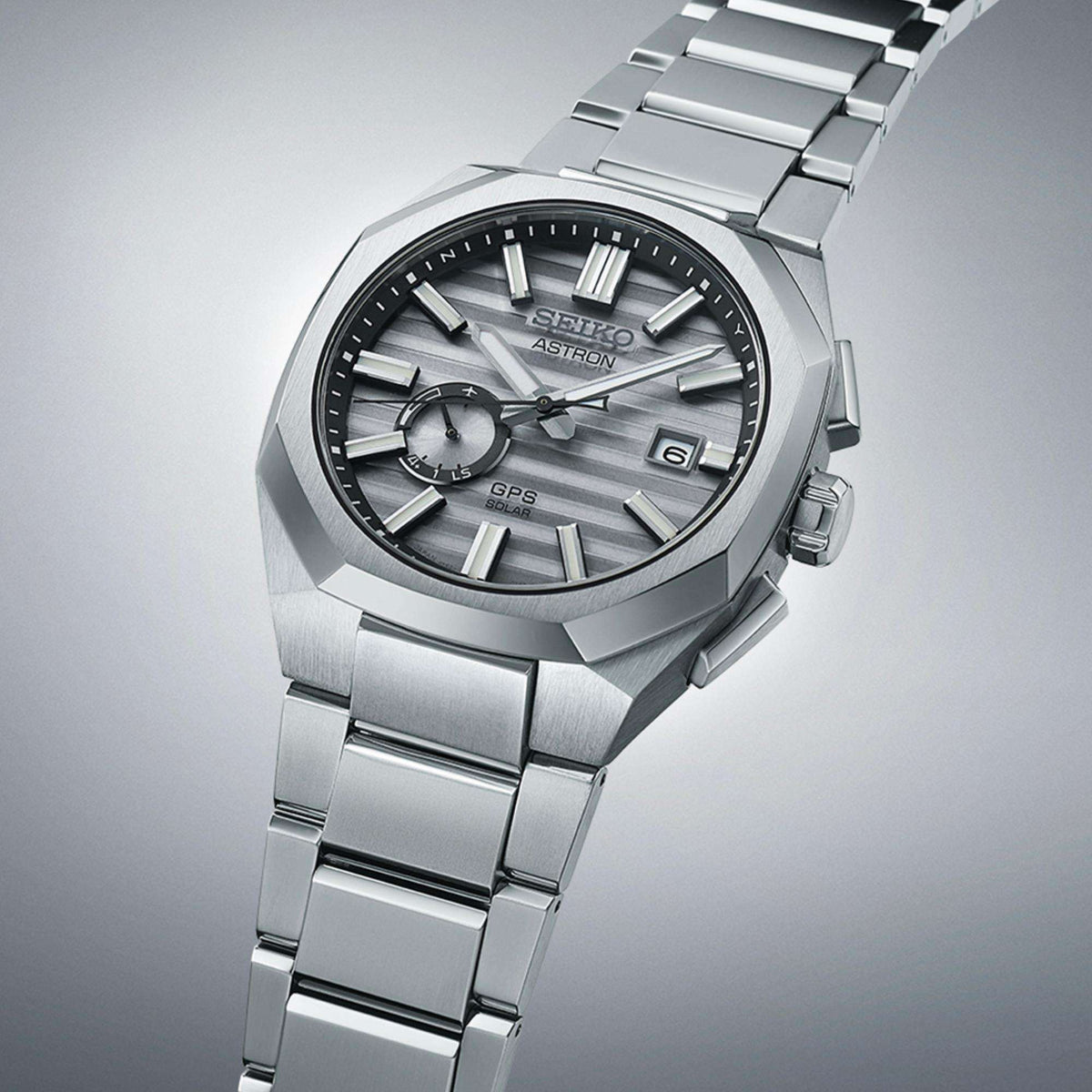 Angled view of the watch emphasizing the titanium case edges and bracelet links.