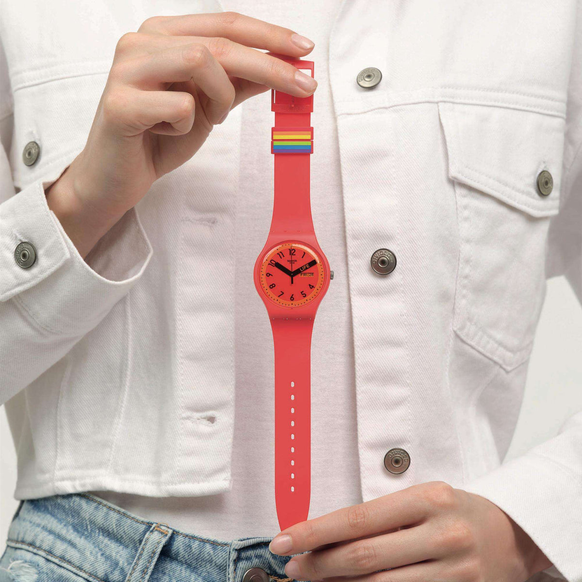 Red unisex quartz watch on red silicone strap with rainbow band accents and black hands.