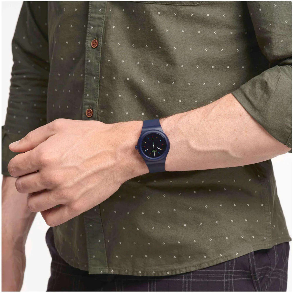 Men's Swatch quartz watch on wrist, blue dial with multicolor markers, navy rubber strap