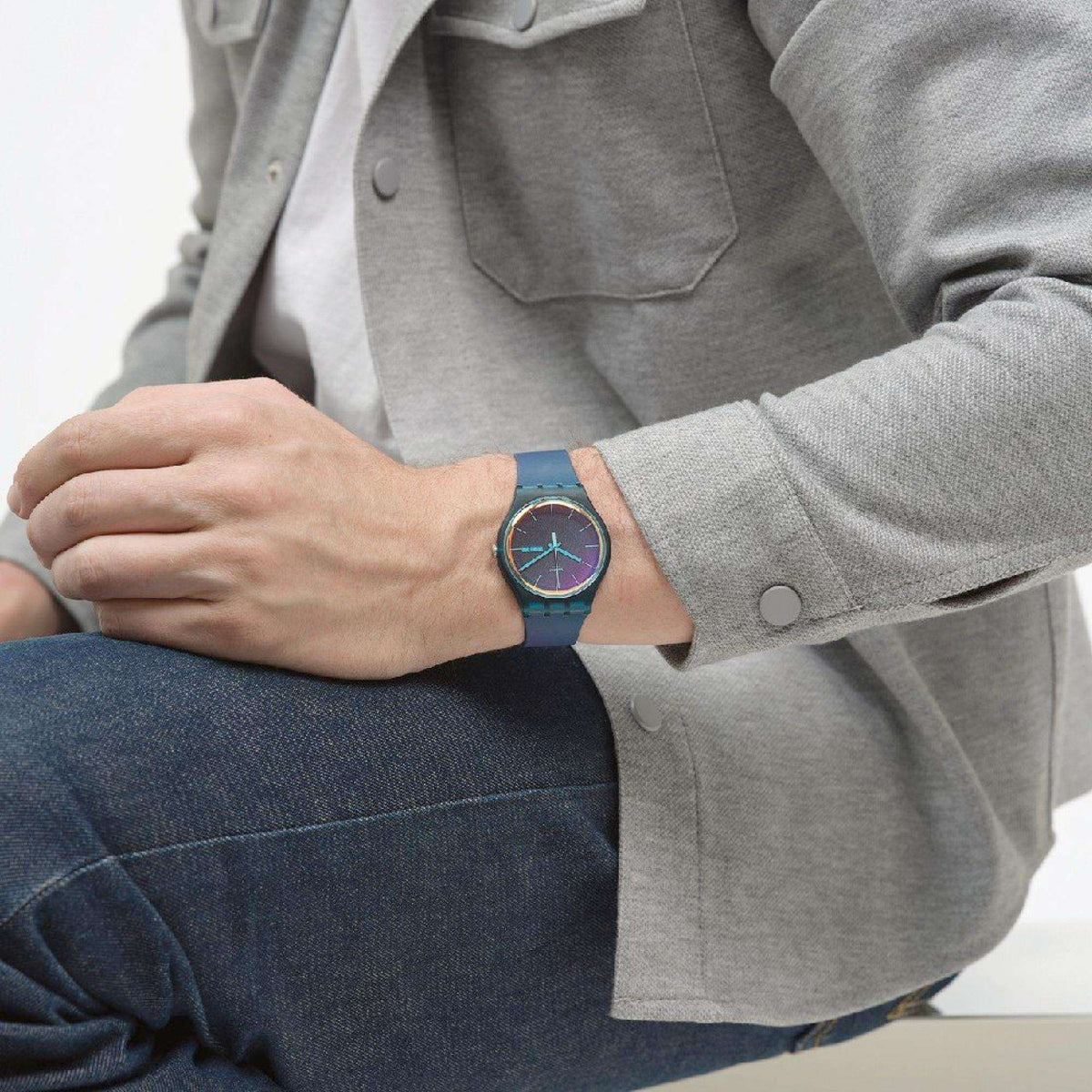 Ladies quartz watch on wrist with dark teal strap and iridescent blue-purple dial