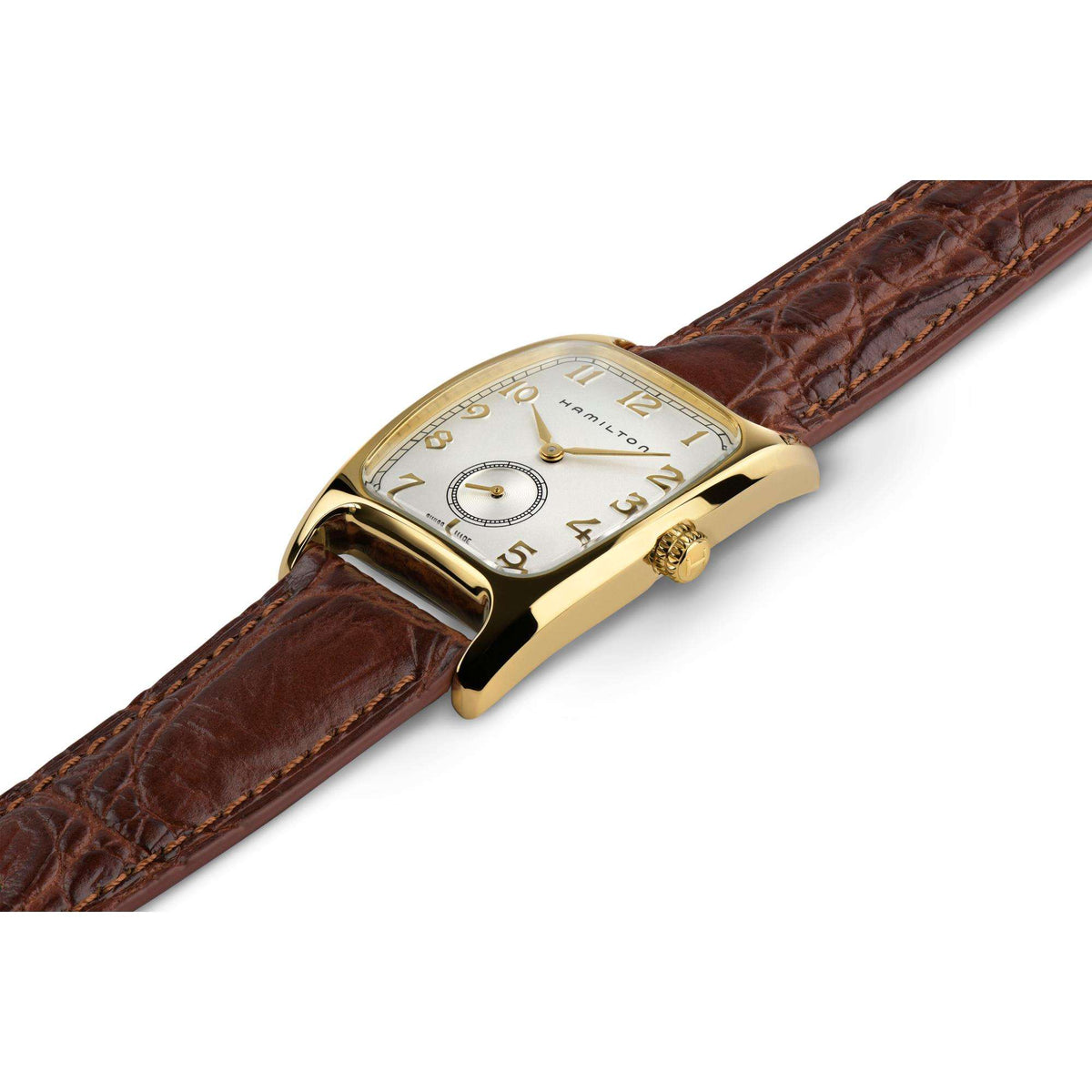 Hamilton American Classic Boulton H13431553 quartz watch laying flat, highlighting yellow gold PVD tonneau case and brown strap