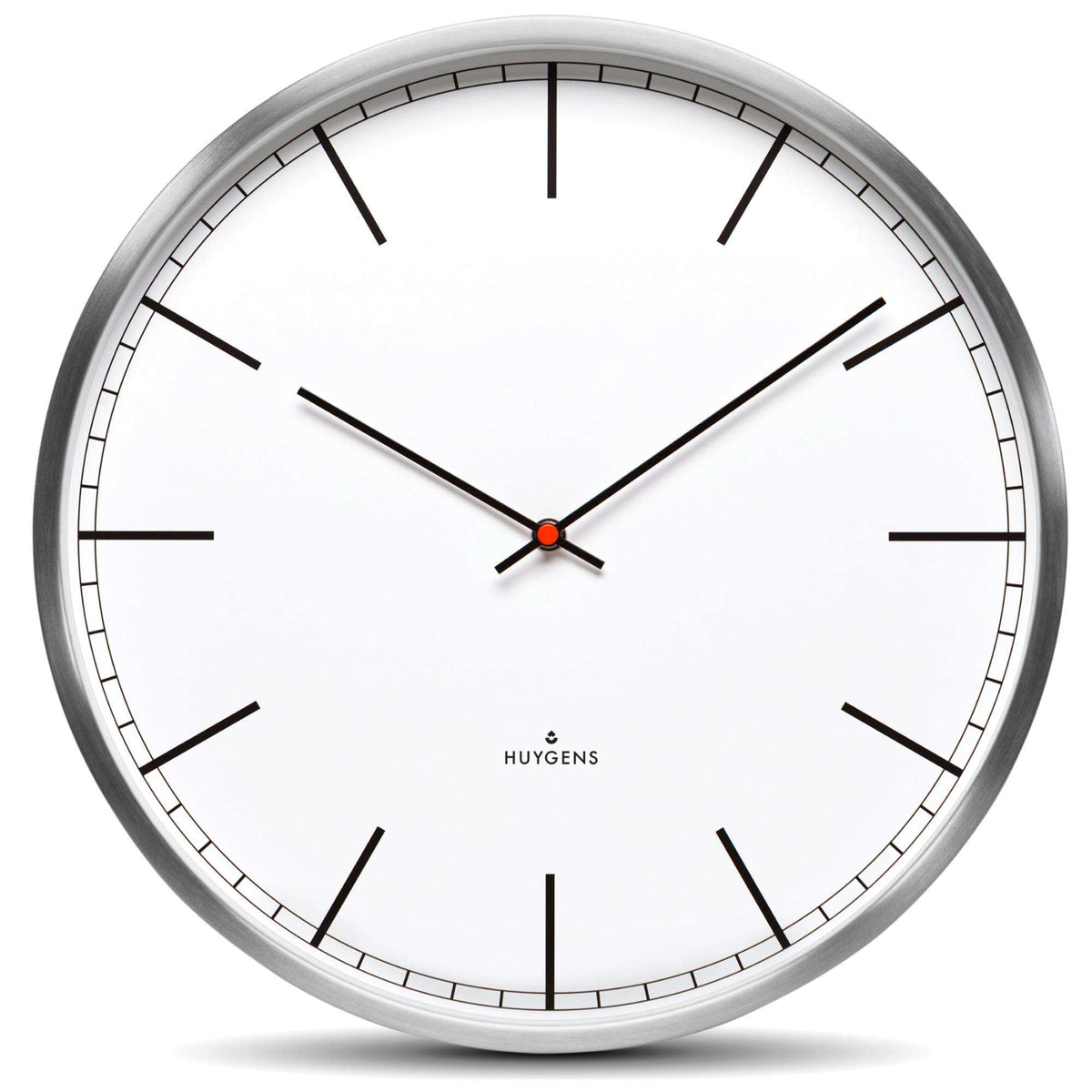 Huygens wall clock close-up: white dial, black index markers, silver frame, red second dot