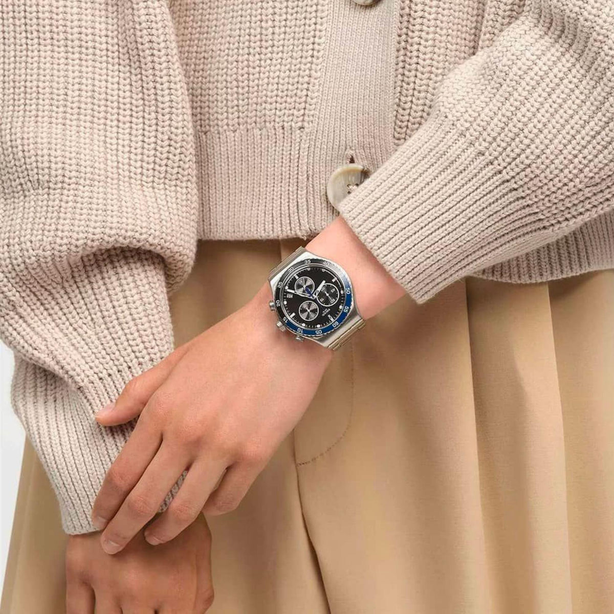 Quartz watch on wrist: silver metal bracelet, dark dial with blue bezel and subdials