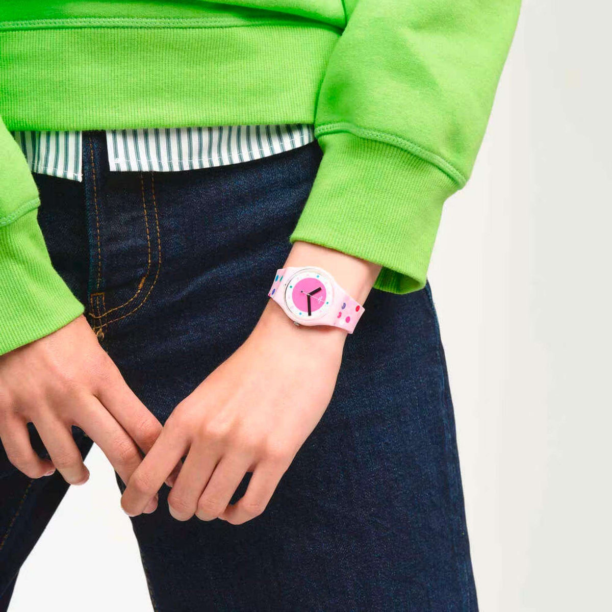 Pink Swatch ladies watch on wrist with bubble dial and pink patterned strap