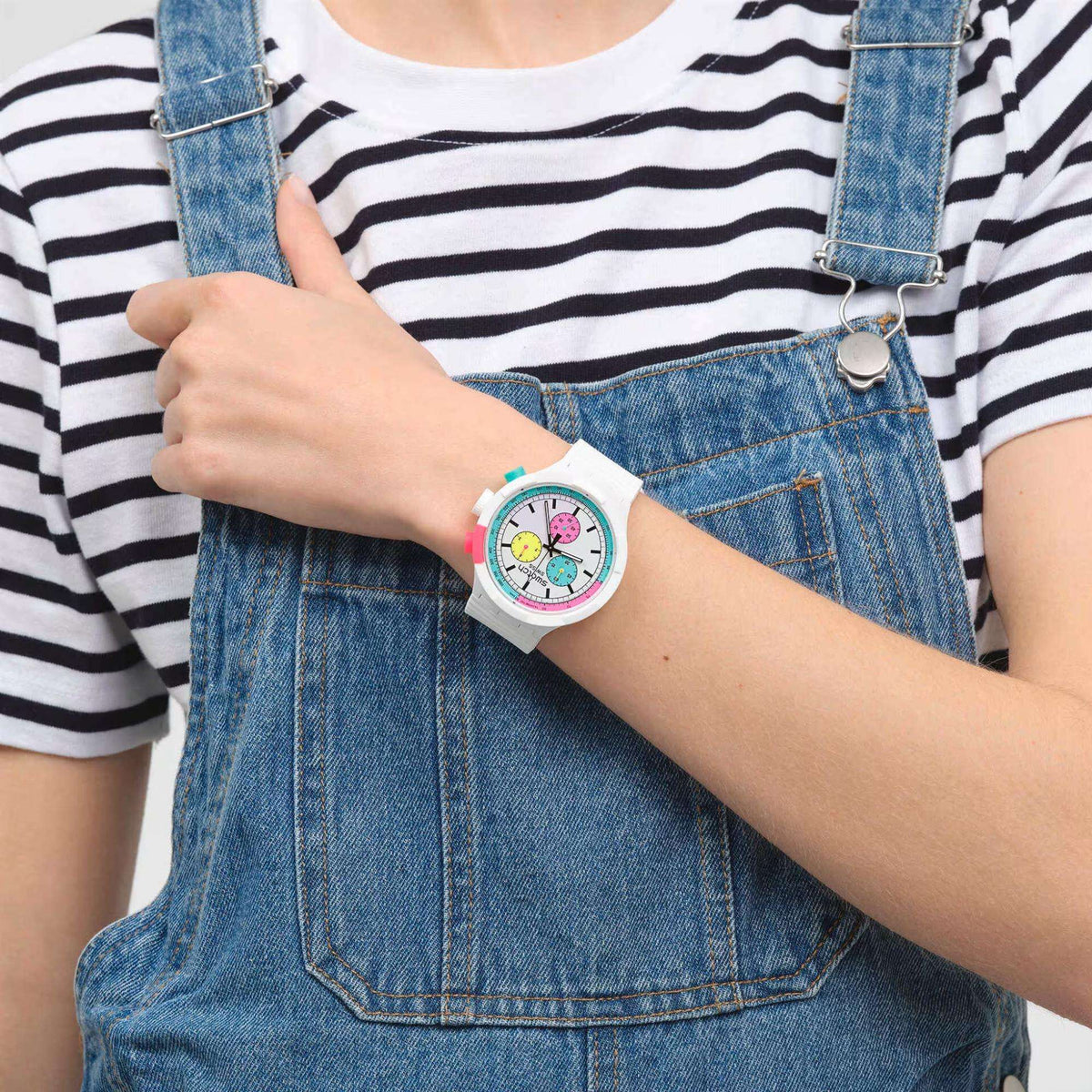 Ladies quartz watch on wrist with white strap and multicolor dial