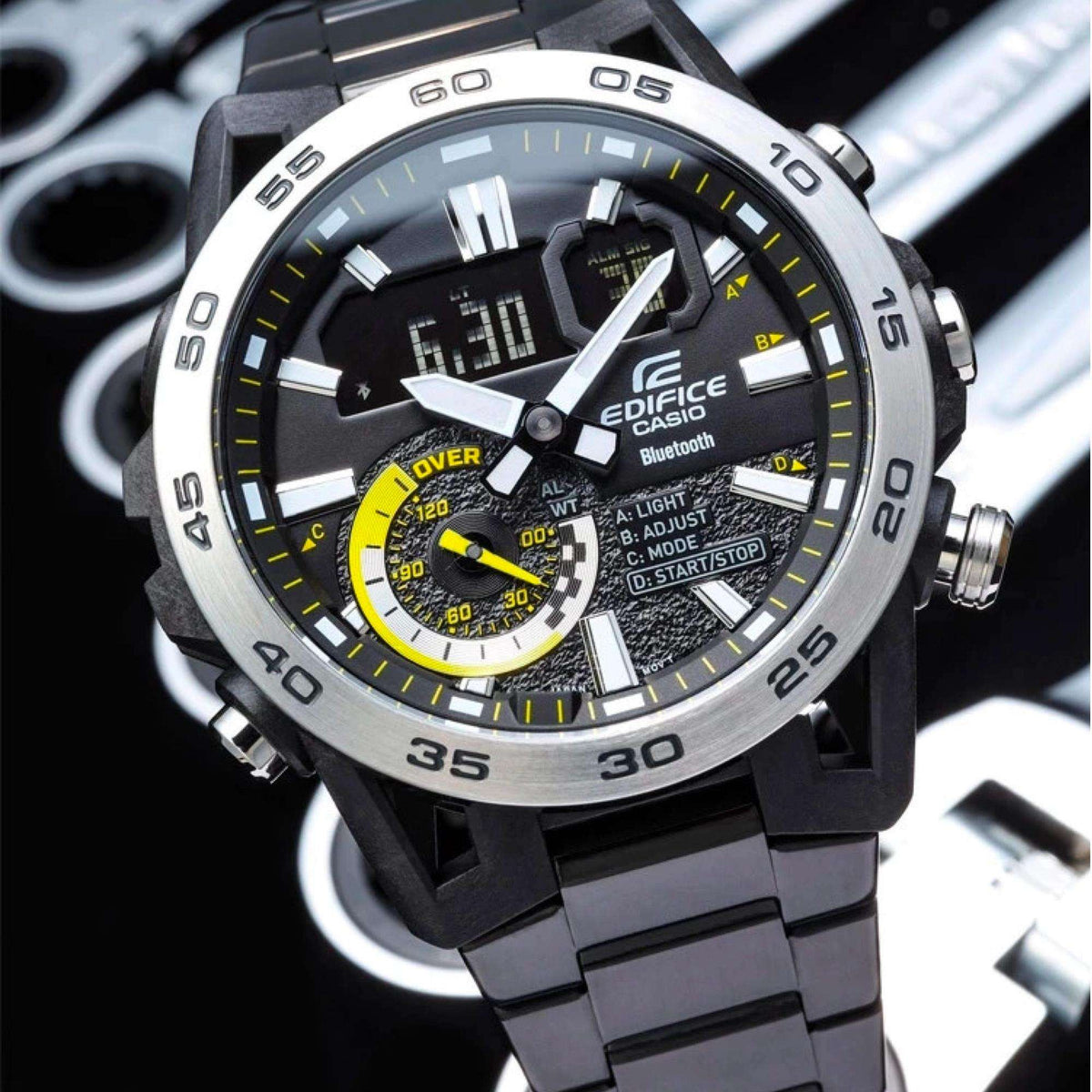 Close-up mens Edifice watch face with digital display, black dial, and yellow subdials