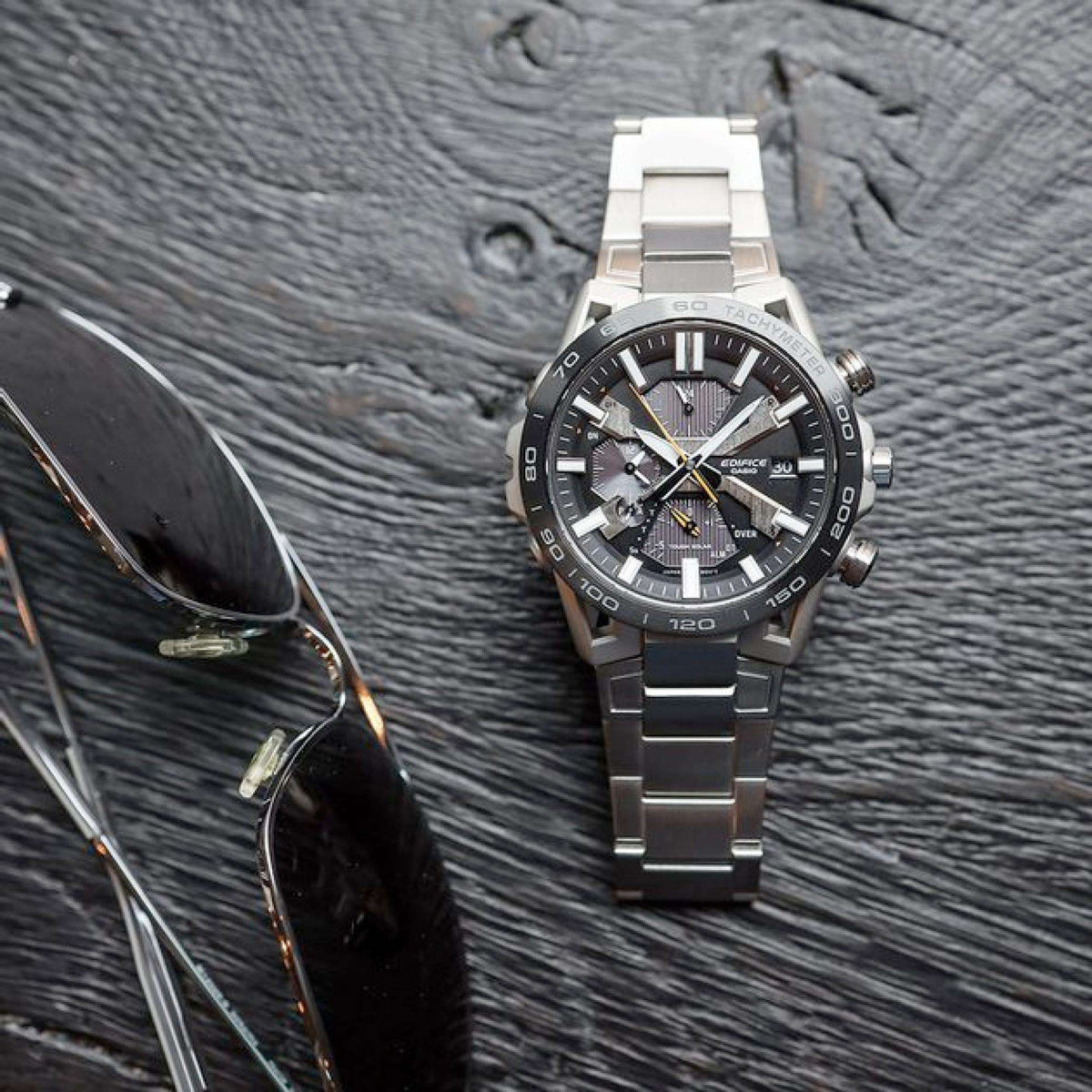 Men's steel chronograph watch on bracelet with black dial and tachymeter bezel