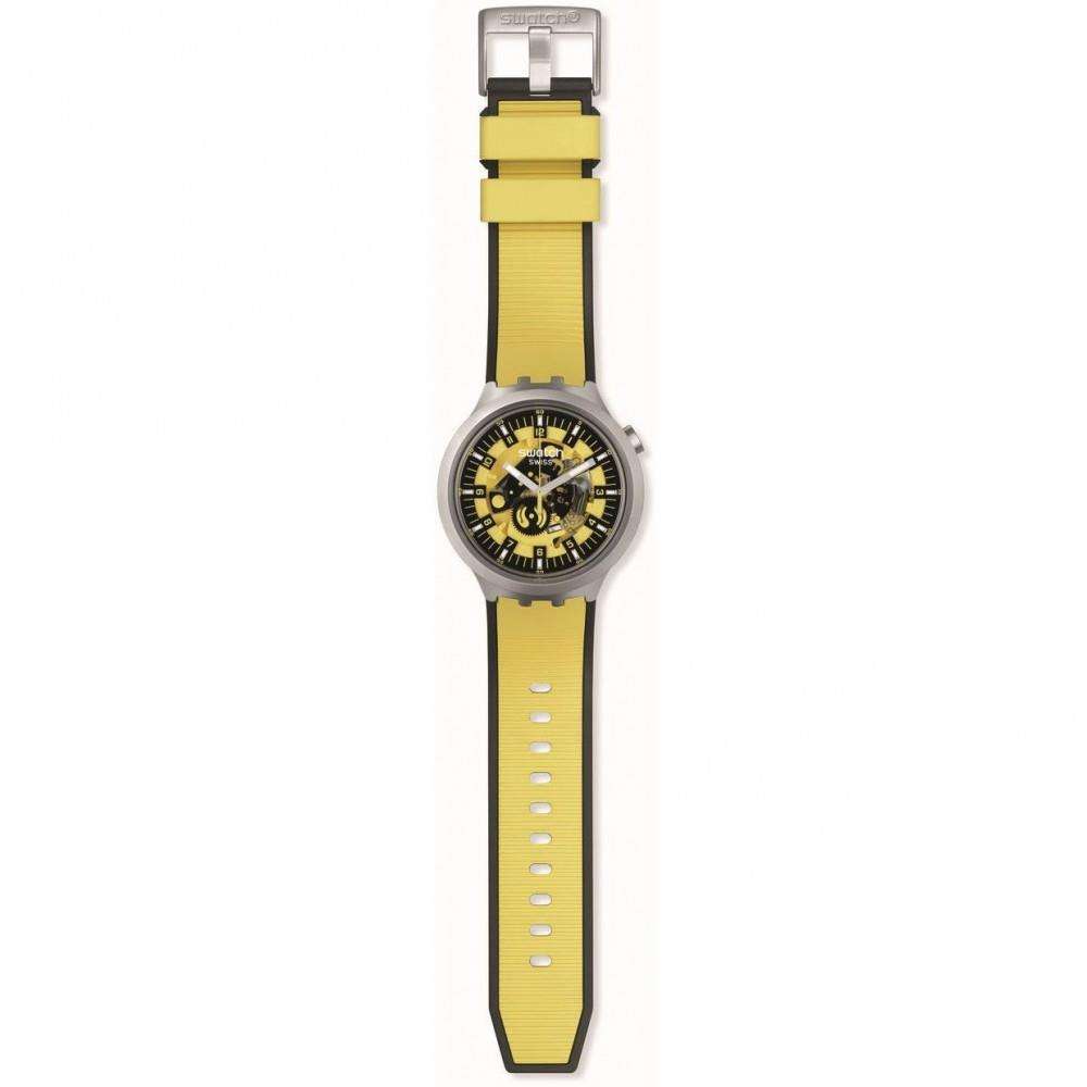 Men's Swatch yellow silicone strap watch with black dial and gray case, side view.