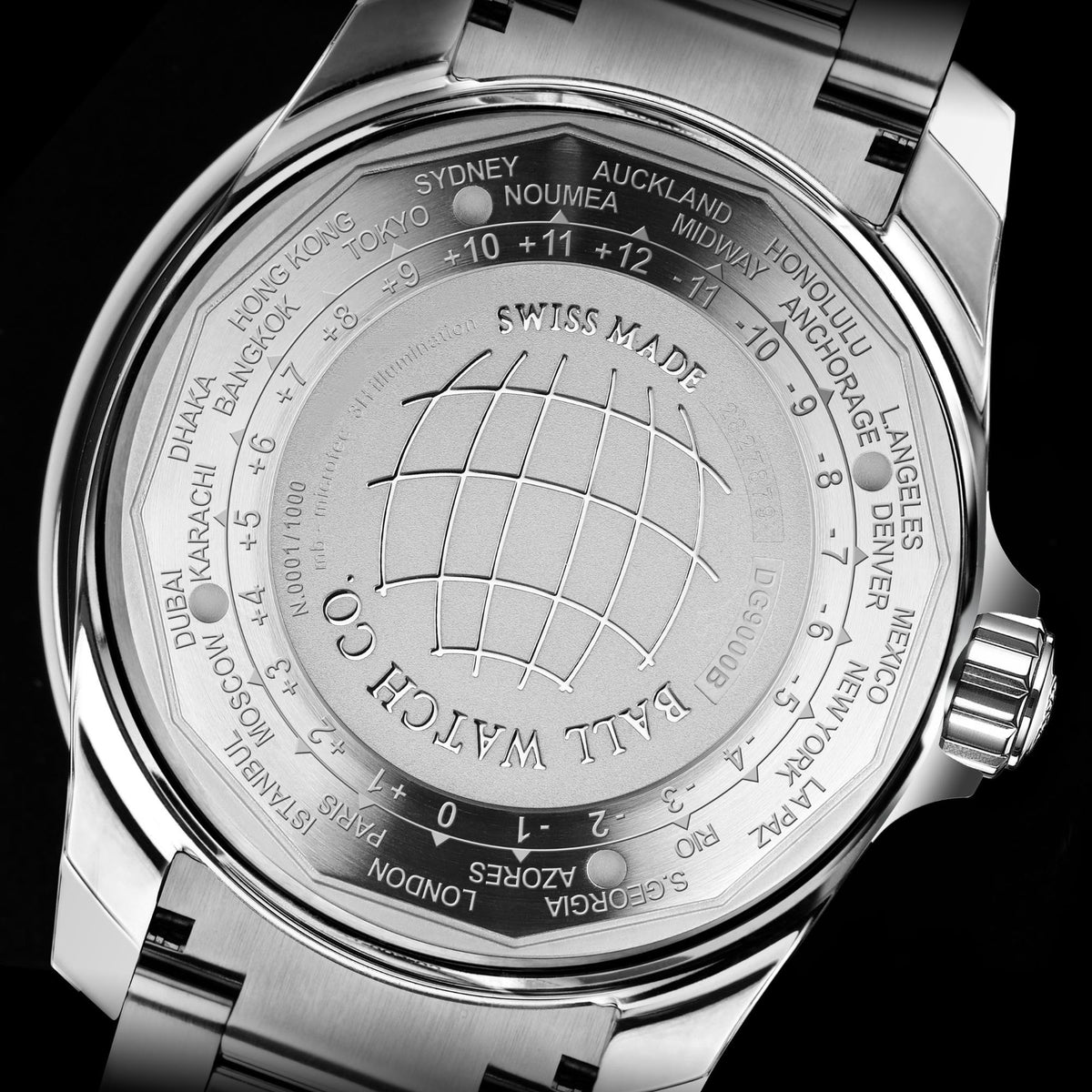 Stainless steel caseback with globe design and engraved city names, date marker visible