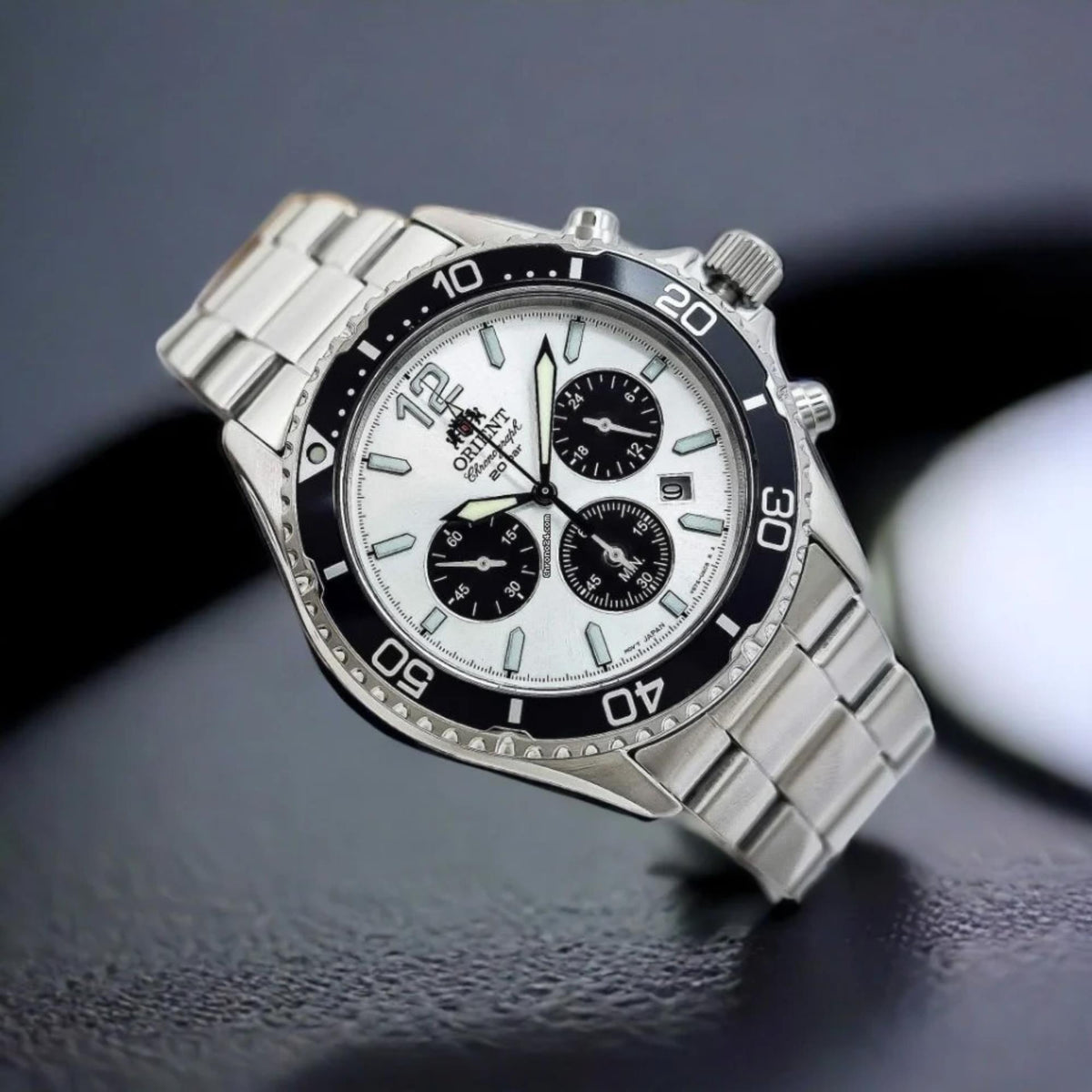 Men's Orient solar chronograph watch with white dial, black bezel, steel bracelet