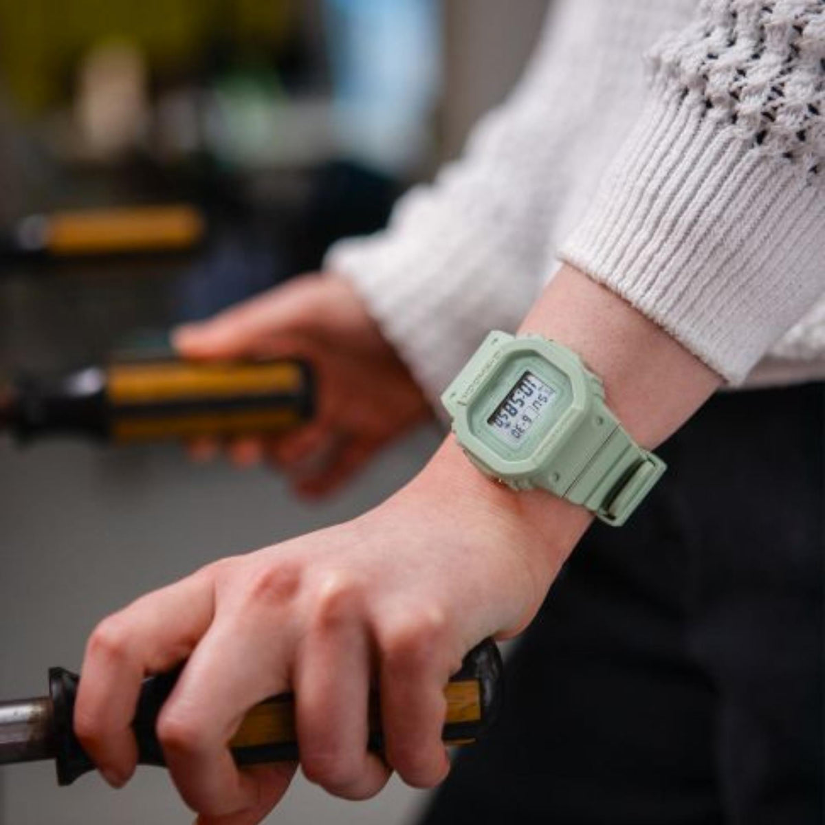 Green G-Shock digital watch on wrist with ribbed green resin strap