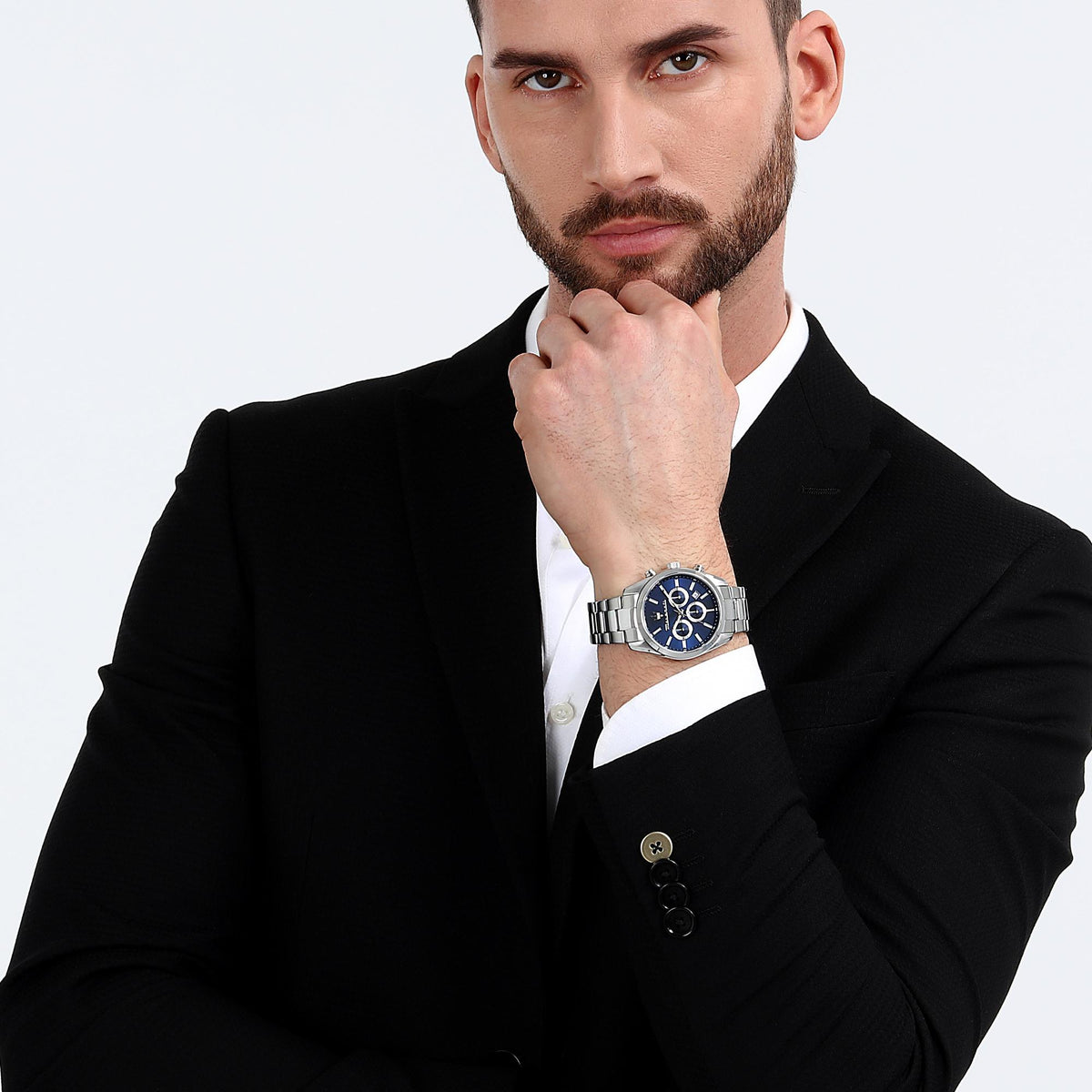Men's wrist chronograph watch with blue dial and steel bracelet on a model in a suit