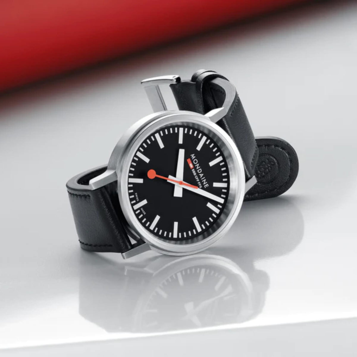 Mondaine stop2go watch with black leather strap and silver case, angled front view