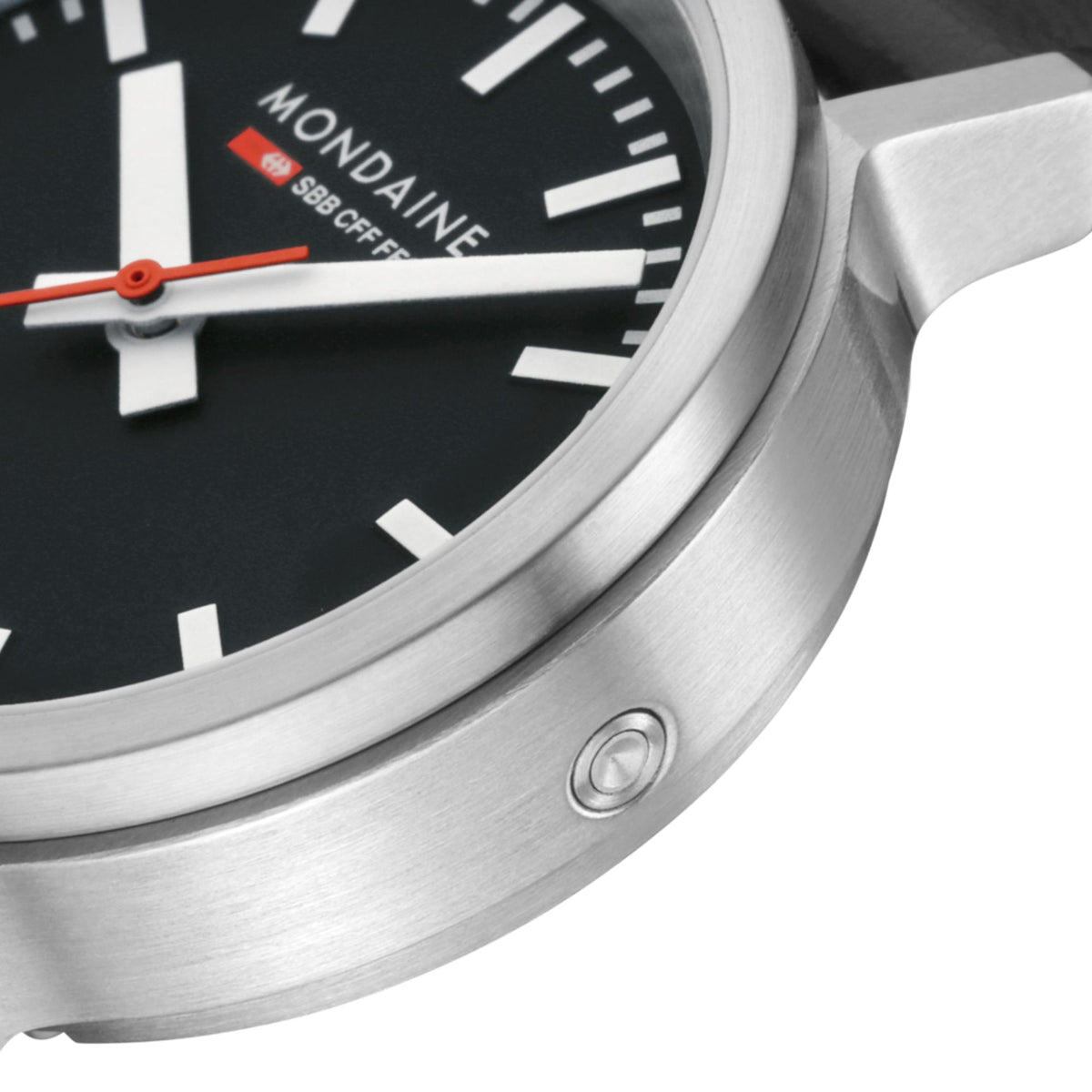 Close-up of stainless-steel watch case edge and crown, black dial with orange hand