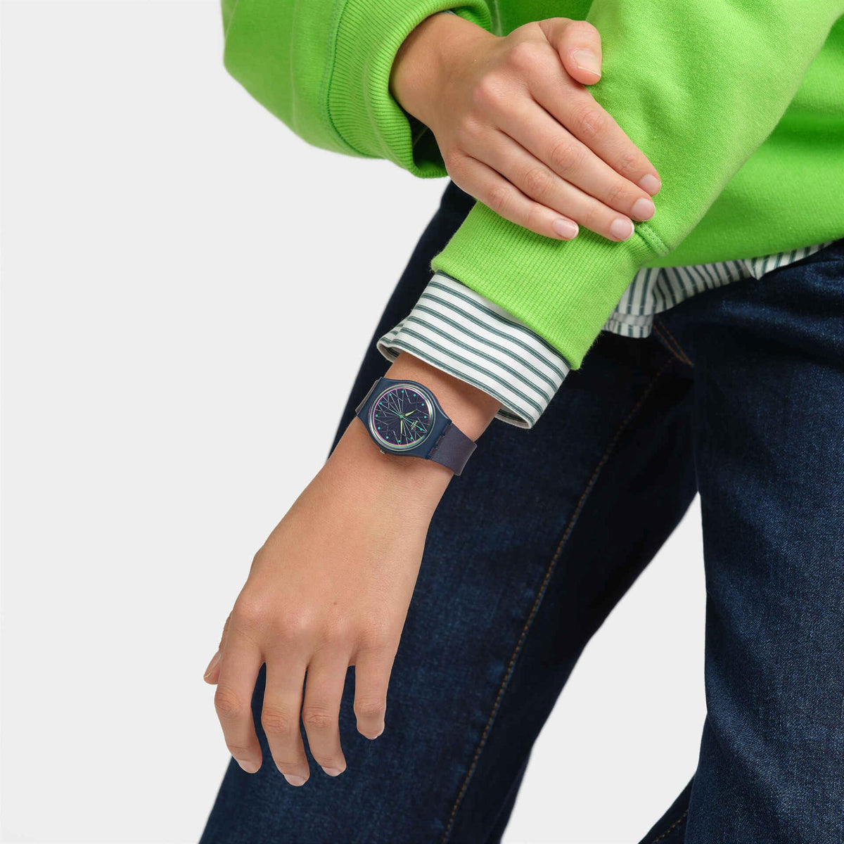 Silicone wristwatch with blue dial and yellow hands on wrist