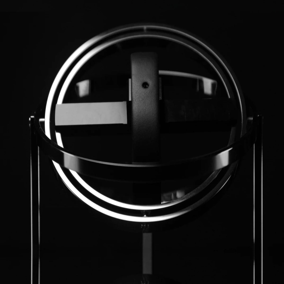 Single-slot watch winder with clear dome and black central support, glowing ring
