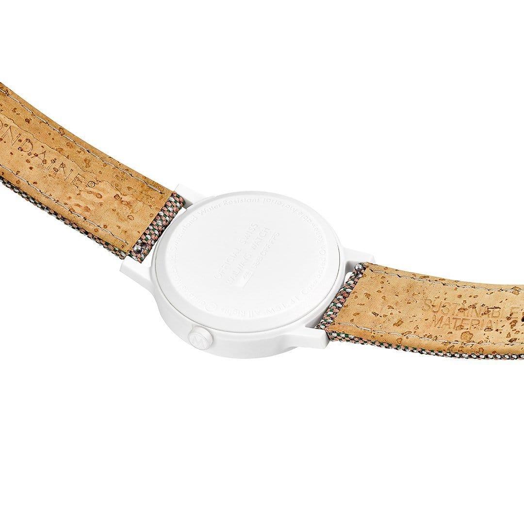 Quartz wristwatch with white case back and brown strap underside.