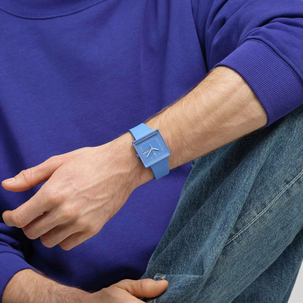 Blue square dial quartz watch with blue strap on wrist