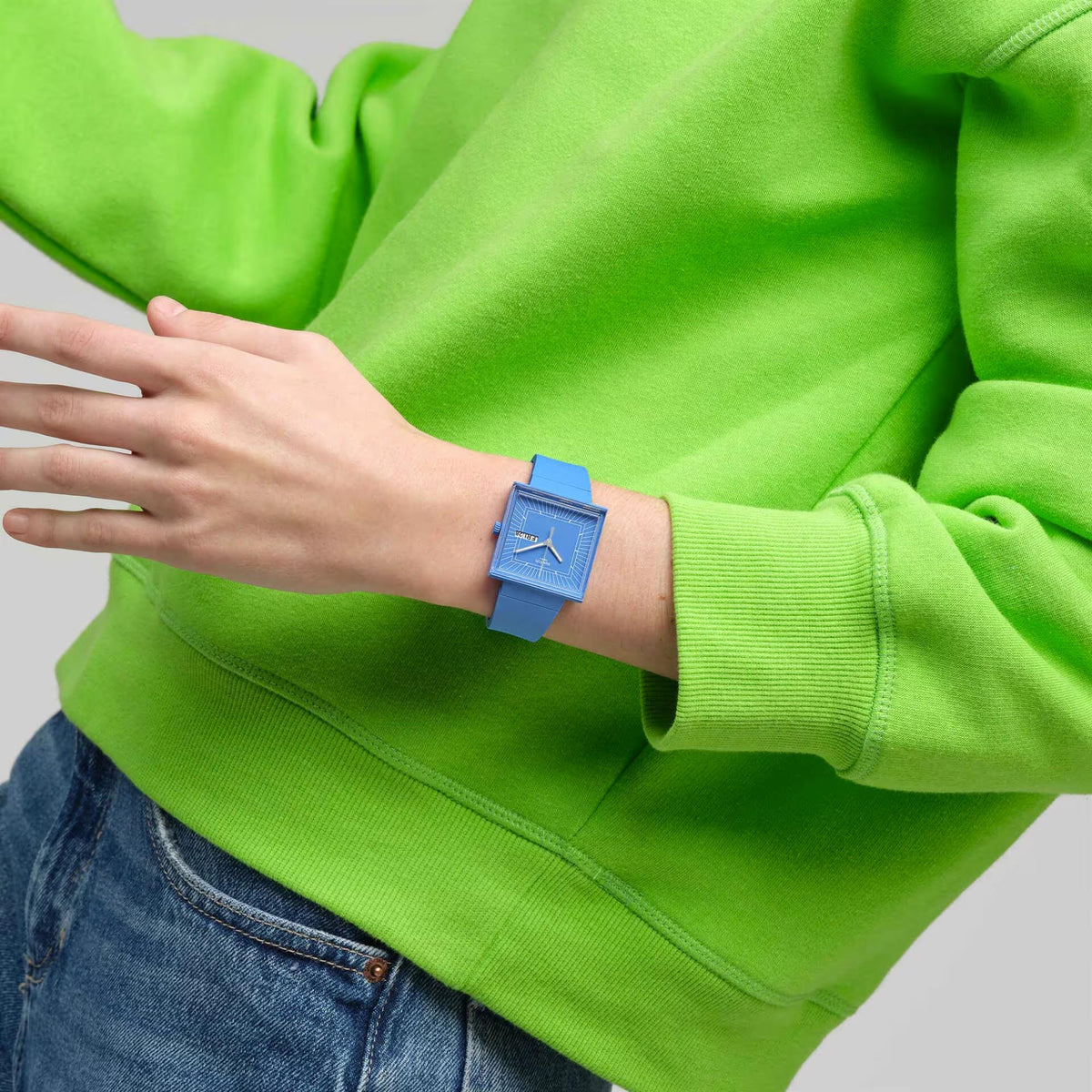 Blue square dial quartz watch with blue strap on wrist