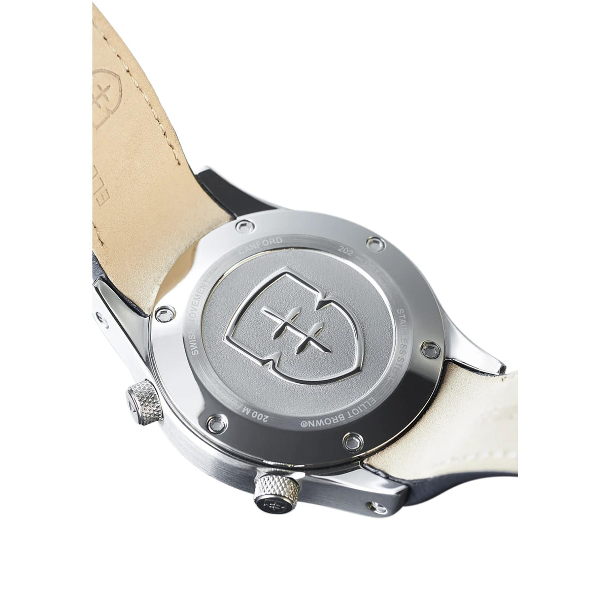 Men's leather strap watch side view showing silver caseback and cream leather strap