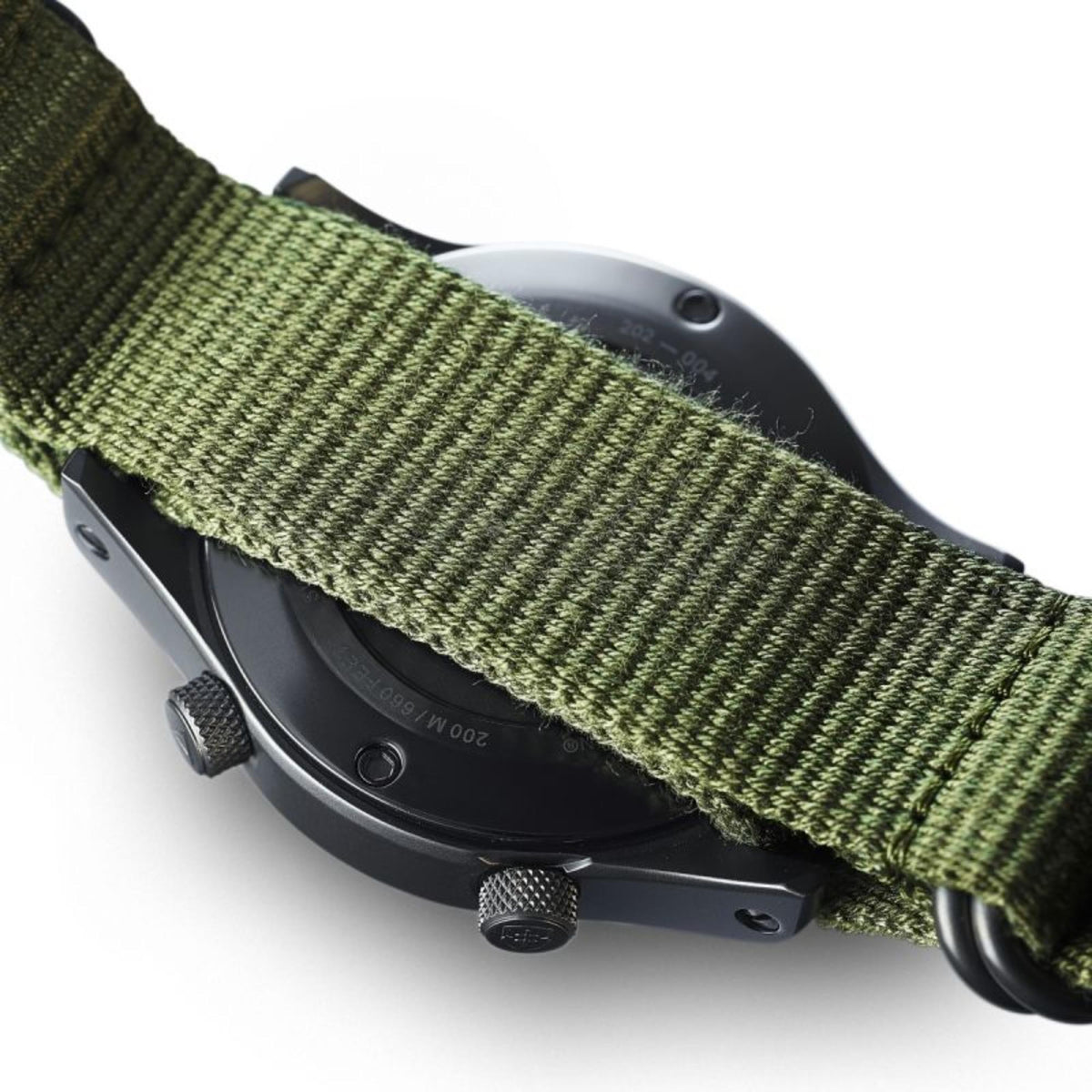 Green textile watch strap with black case side and crown detail