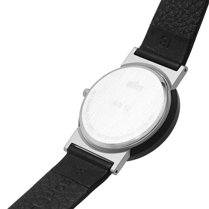 Men's black leather watch with visible case back, engraved markings on the back plate