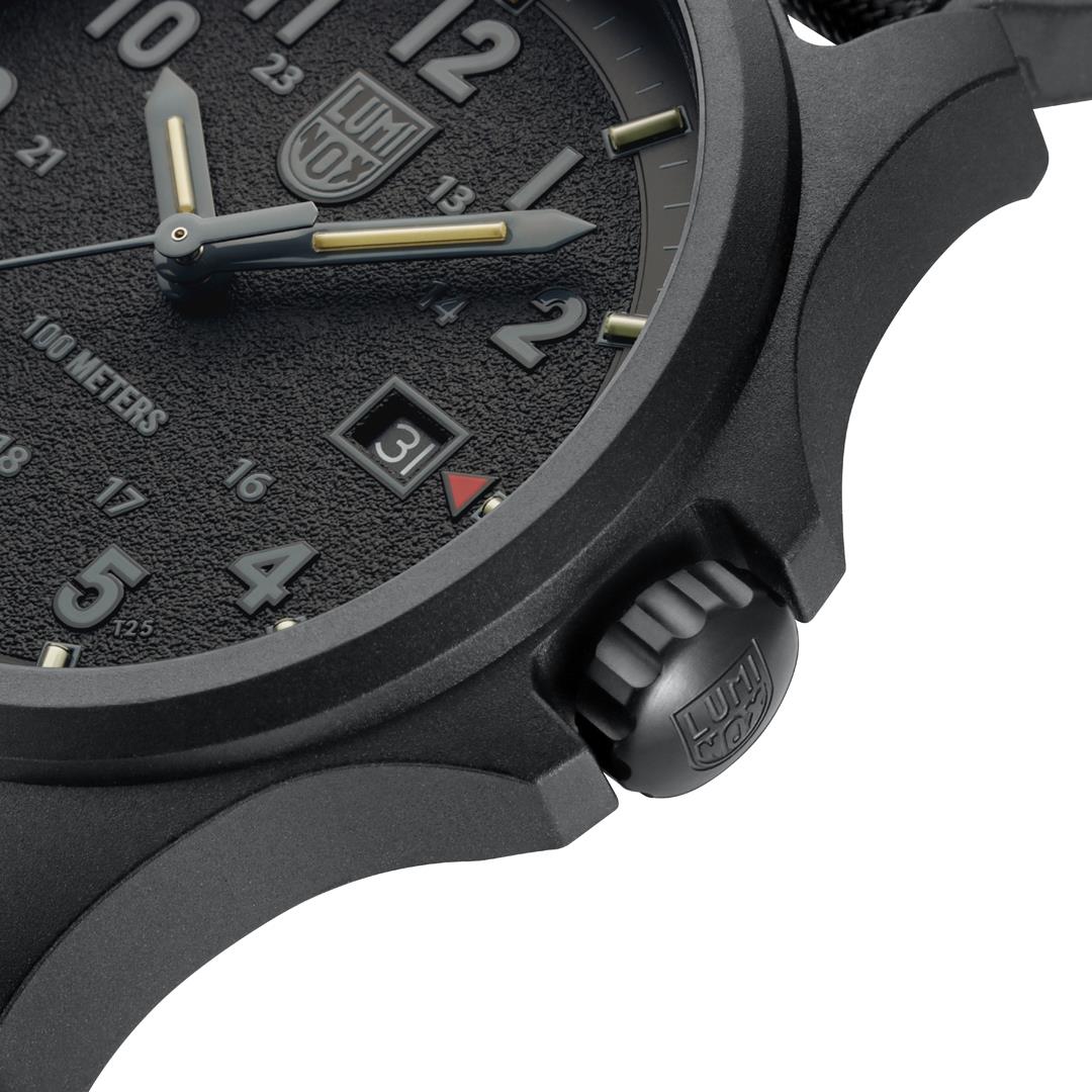 Side close-up of black sport watch case with textured crown and strap