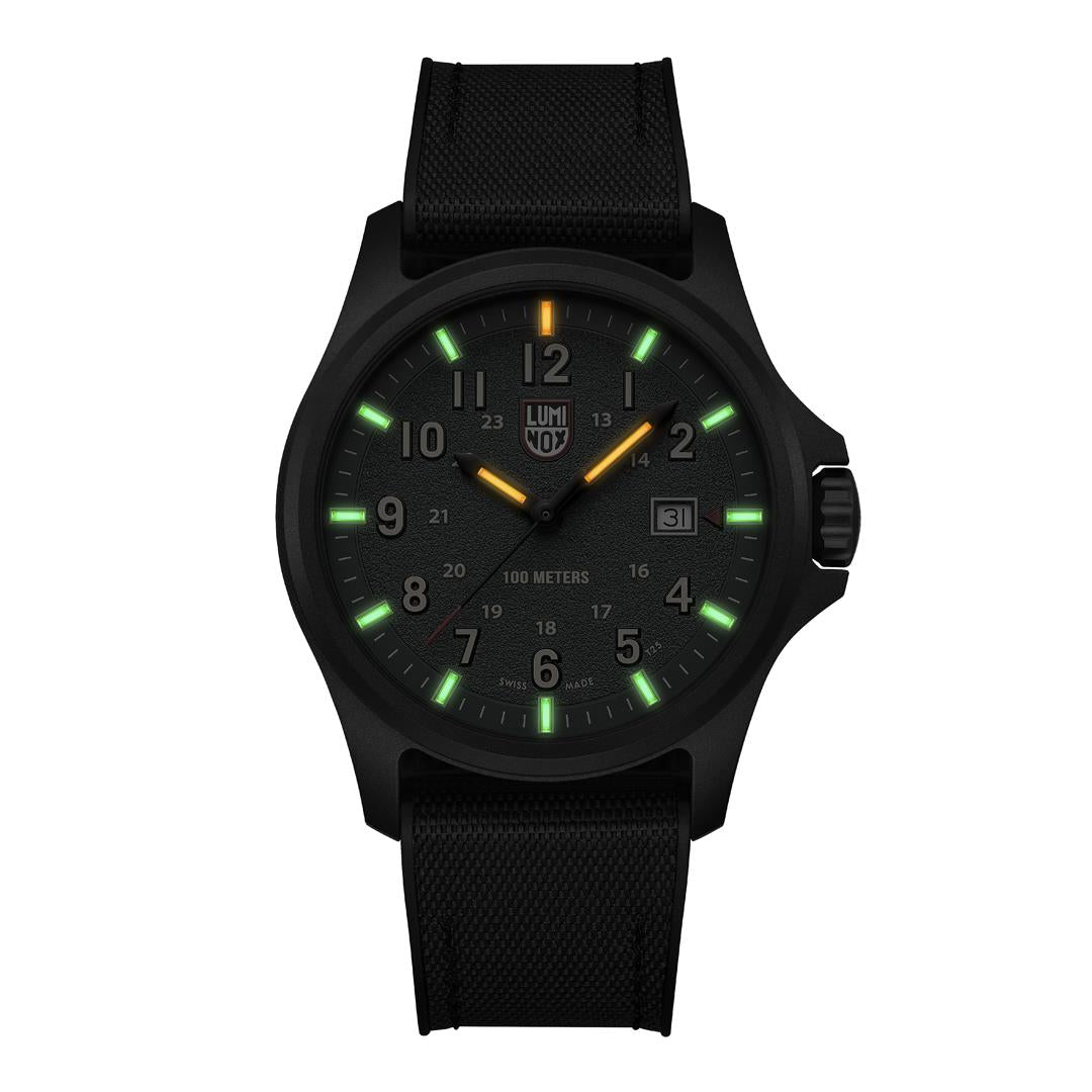 Luminous night display of the Luminox Atacama Field XL.1977 watch showing green and orange illuminated hands and indices