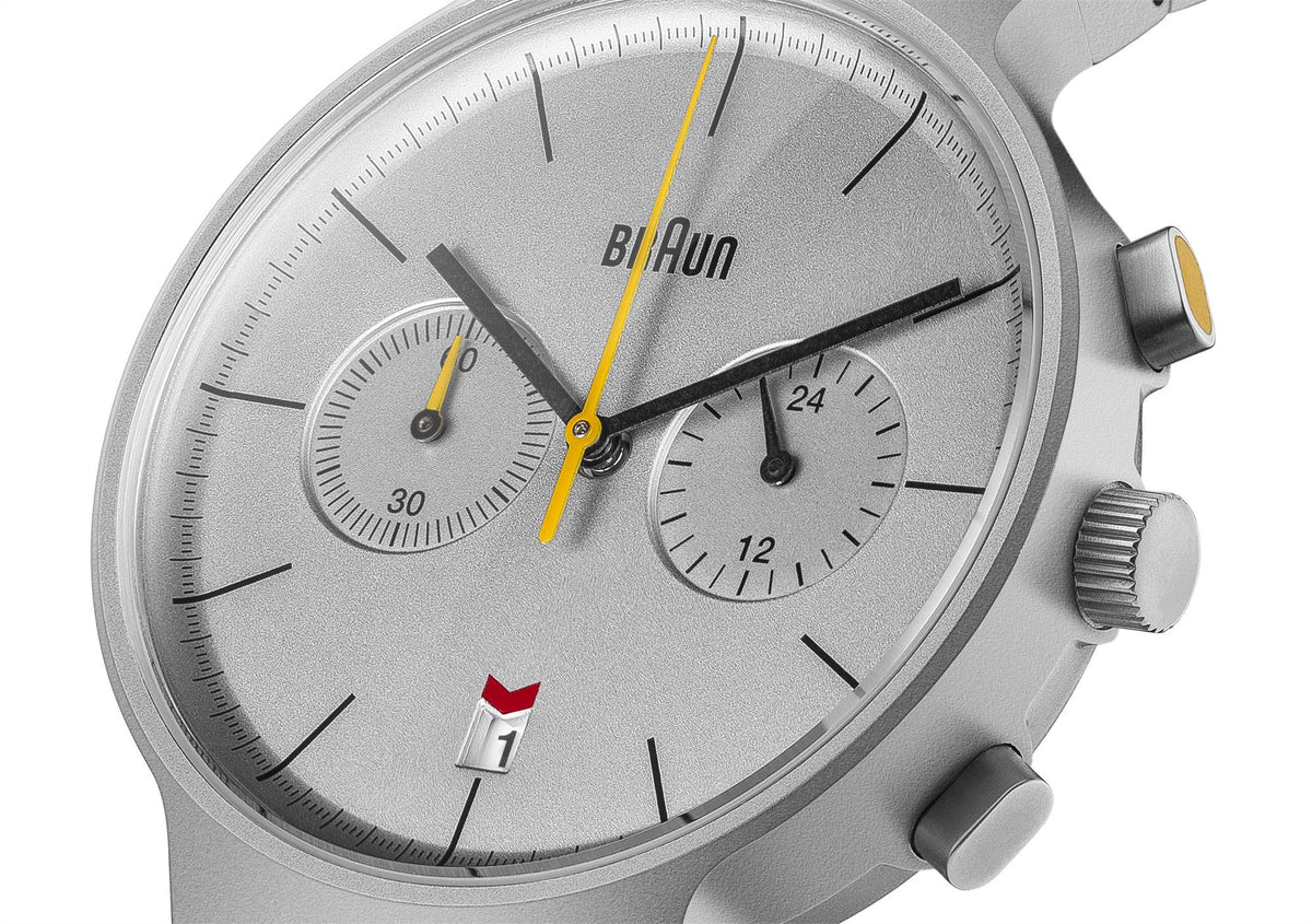 Men's steel quartz watch close-up, silver dial with yellow accents and subdials.