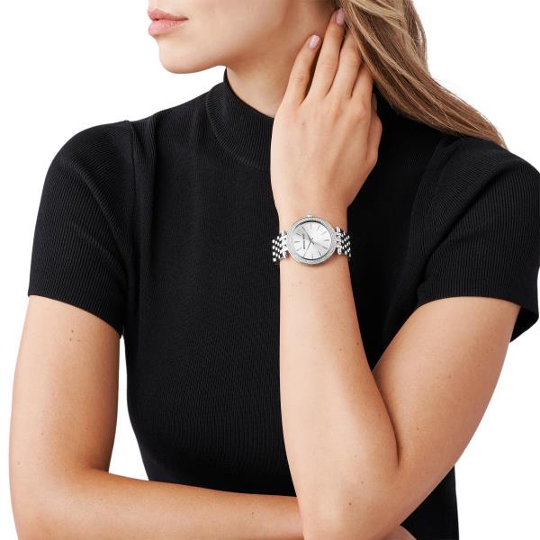 Silver dial ladies watch on wrist with metal link bracelet