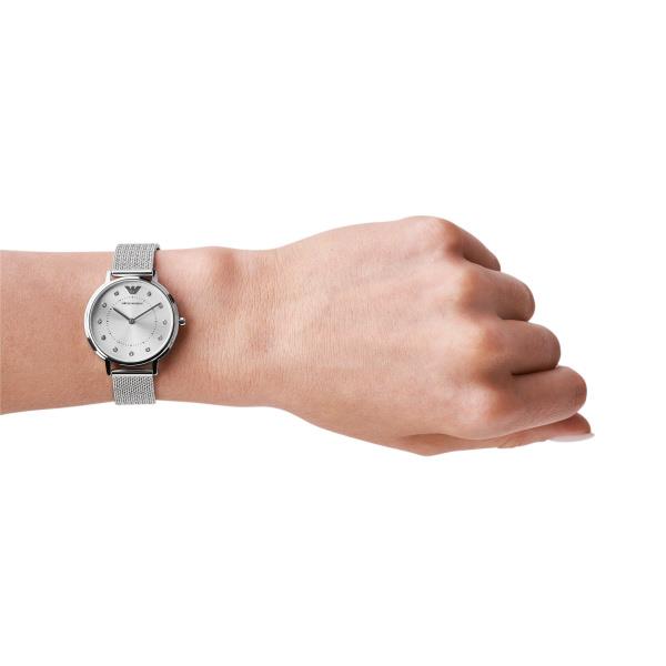 Ladies quartz watch on wrist with silver dial and steel mesh link bracelet
