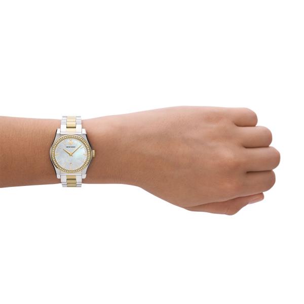 Two-tone steel quartz ladies watch on wrist with mother-of-pearl dial, gold markers