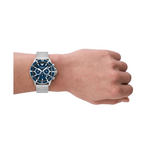 Men's blue-dial steel chronograph watch on wrist with mesh link bracelet