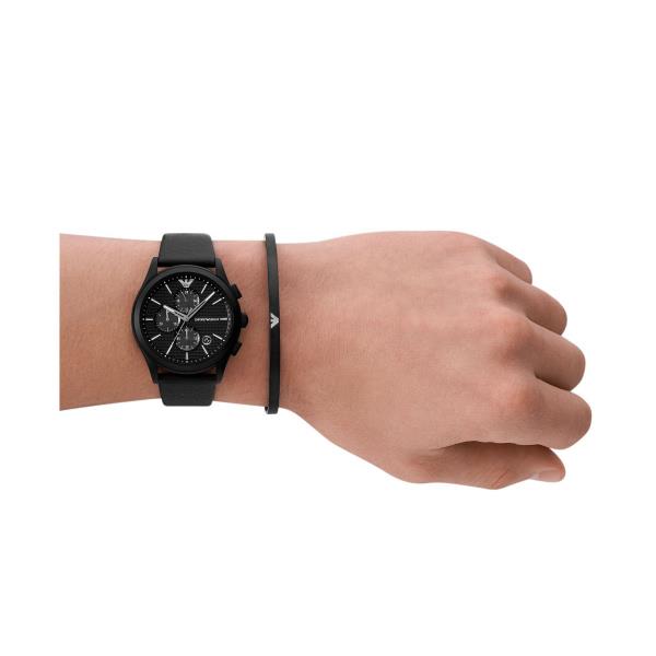Black chronograph wristwatch on wrist with black leather strap