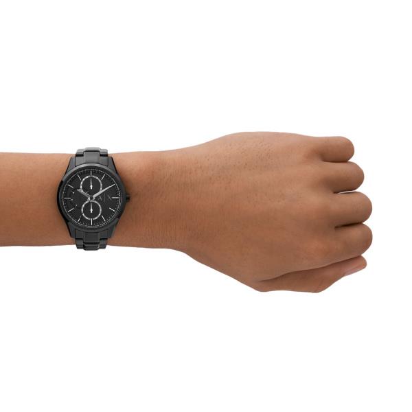 Men's black chronograph quartz watch on wrist with black dial and steel bracelet