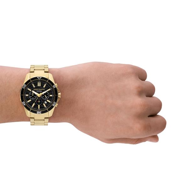Armani Exchange men's chronograph watch on wrist, black dial with gold markers and bracelet.