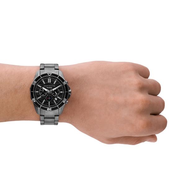 Men's chronograph quartz watch with black dial and steel bracelet on wrist
