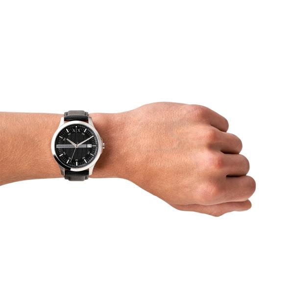 Armani Exchange men’s quartz watch on wrist, black dial and leather strap