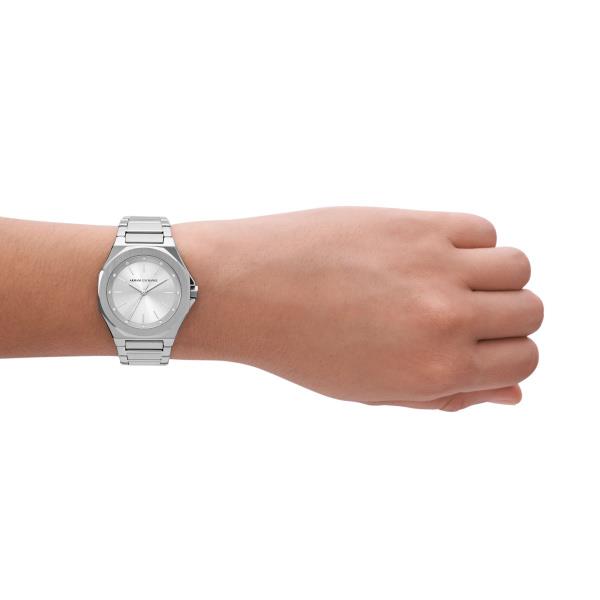 Armani Exchange ladies quartz wristwatch on wrist, silver dial and steel bracelet