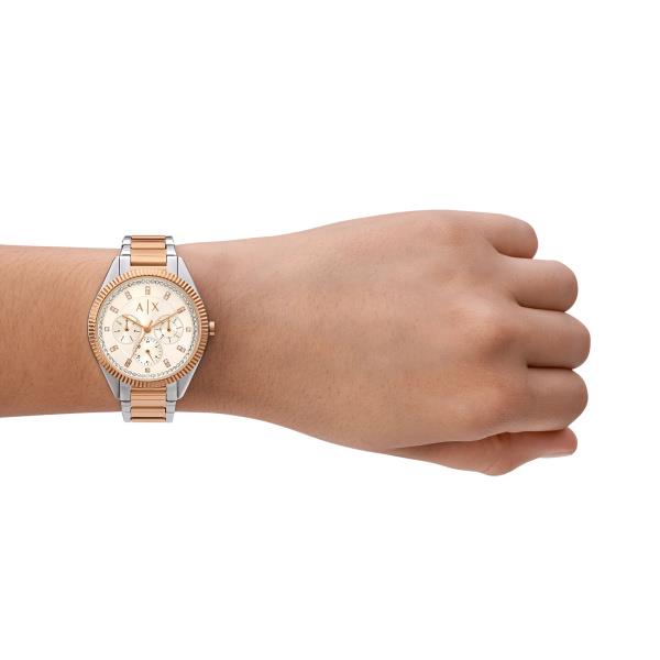 Two-tone steel chronograph watch on wrist with white dial and rose-gold bracelet links
