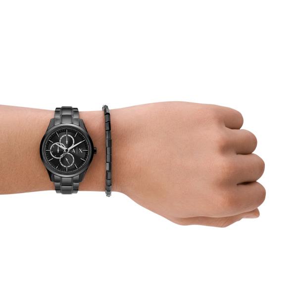 Chronograph watch on wrist with black steel bracelet and black dial