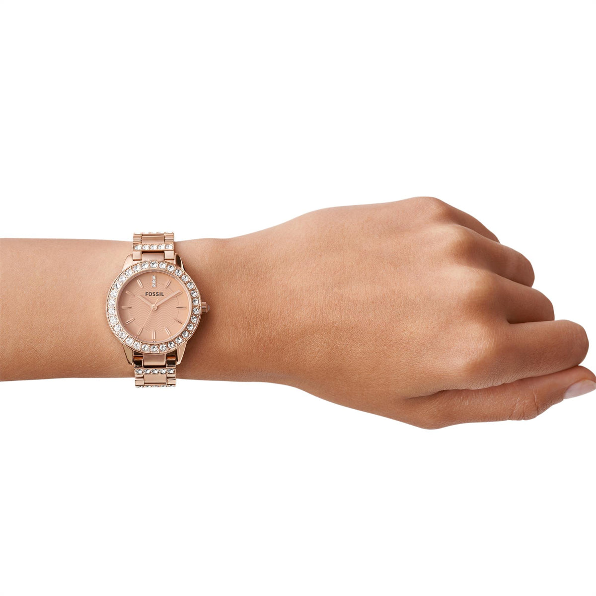 On-wrist lifestyle view of the Fossil Jesse ES3020 mens watch displaying the rose gold-tone case and stone-embellished bezel