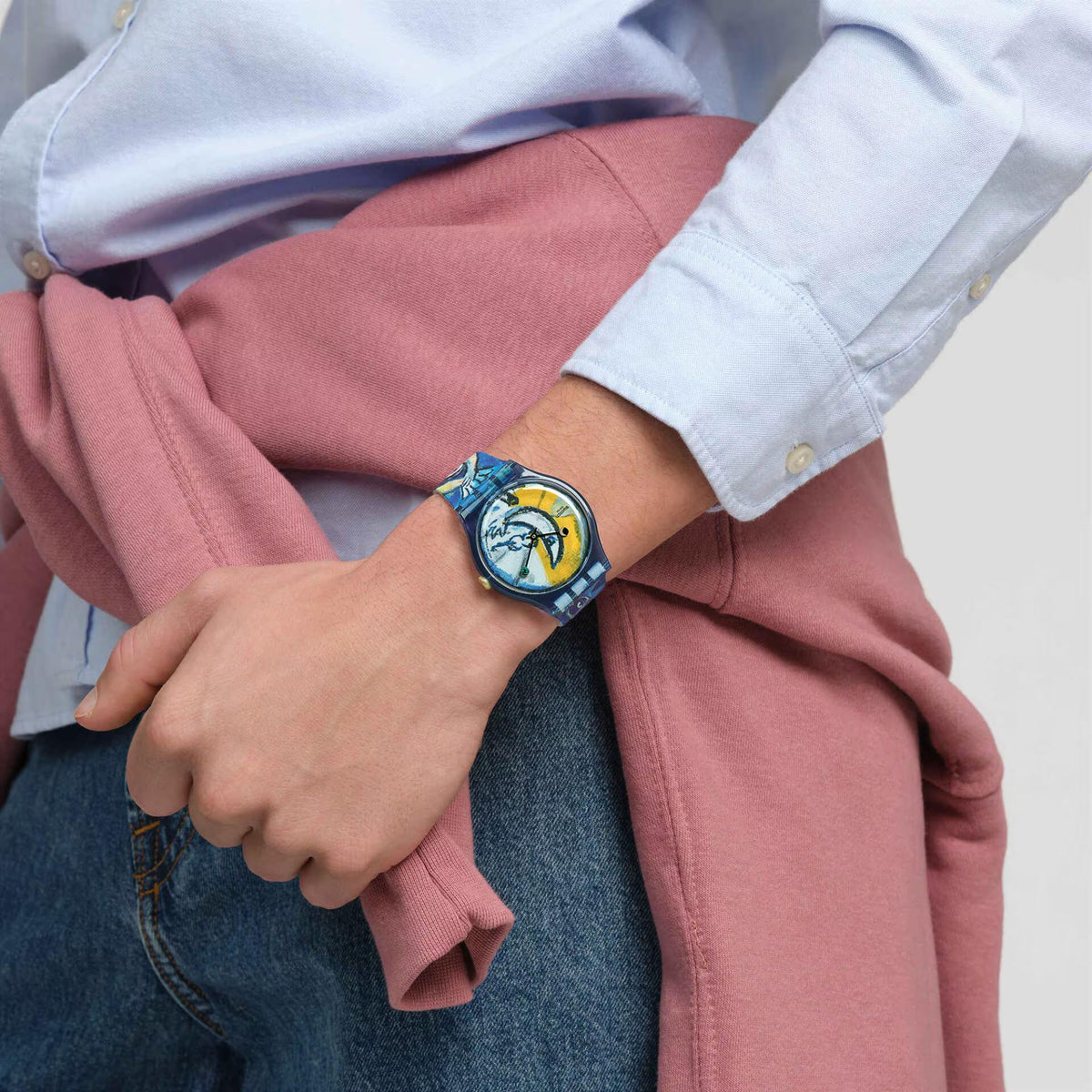 Swatch silicone strap watch worn on arm with blue circus dial