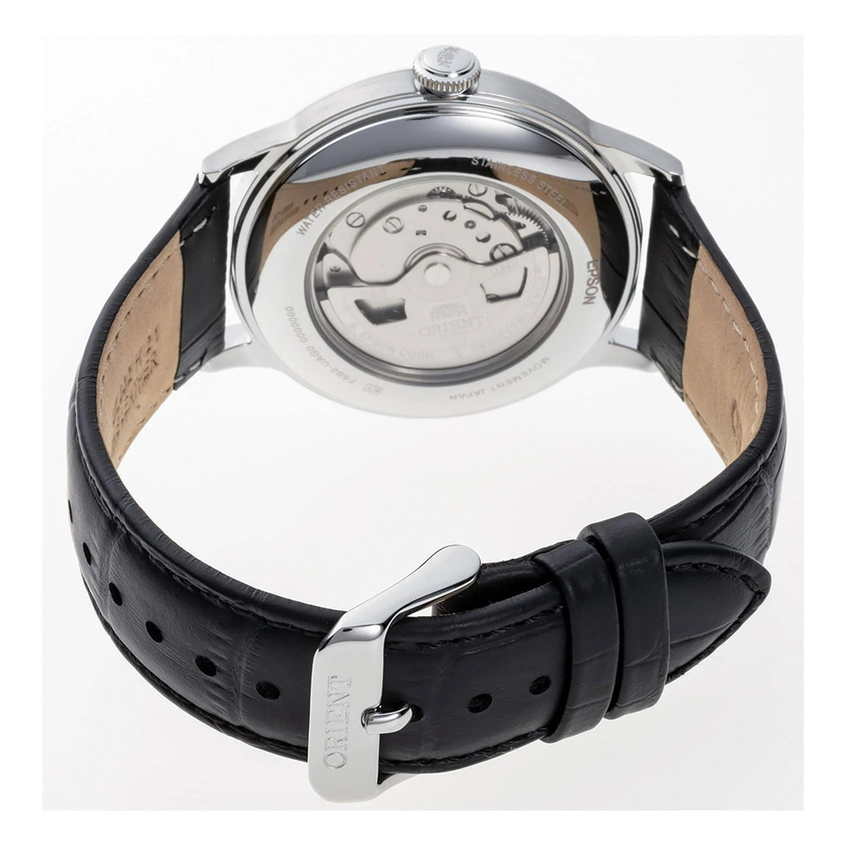 Round watch caseback with visible movement, black leather strap and metal buckle
