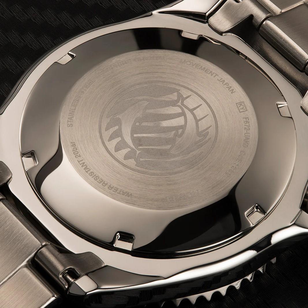 Steel watch caseback with engraved emblem, circular interior, and knurled bezel edge