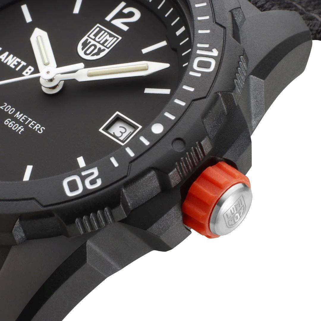 Black rugged watch case close-up with orange crown and textured bezel