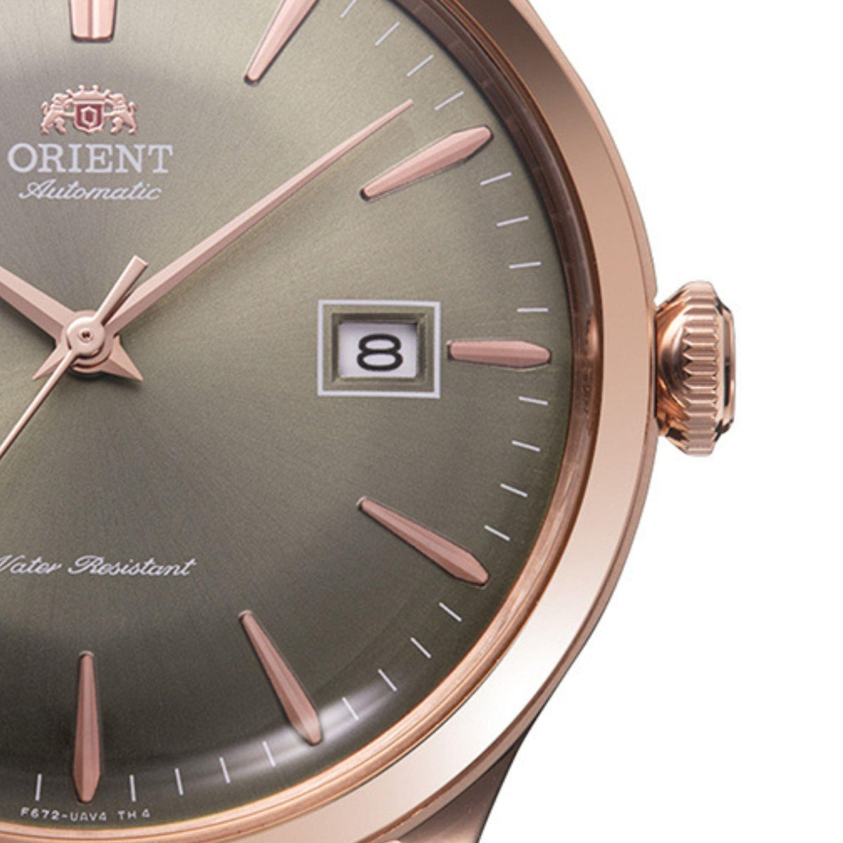 Men's automatic watch dial close-up, date window shows '8' with rose-tone indices