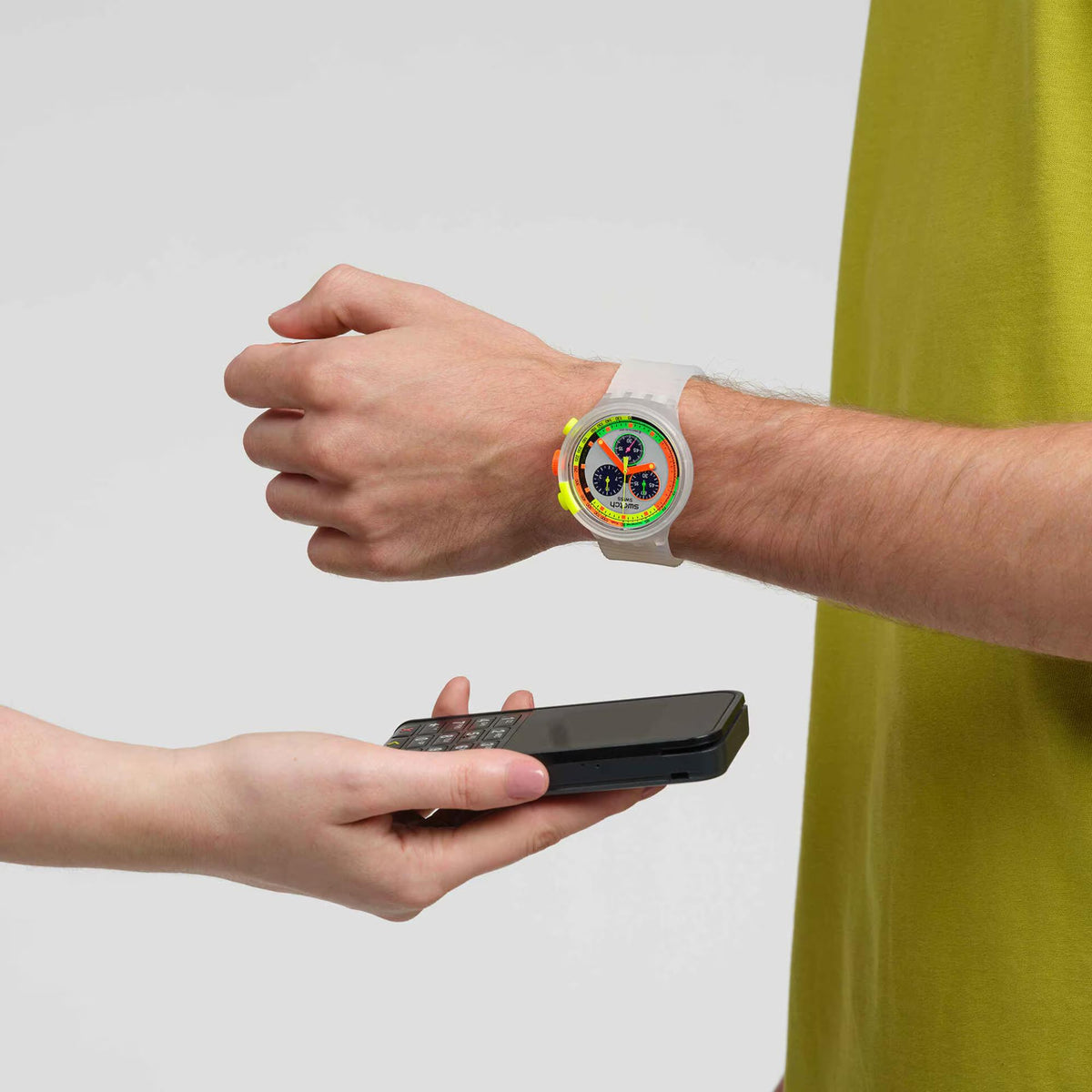 Swatch chronograph watch on wrist with white silicone band and neon multicolor dial
