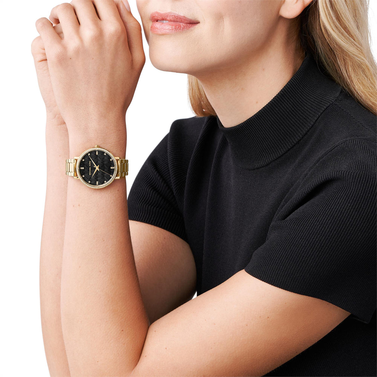Michael Kors Pyper women's watch on wrist, black dial with gold-tone link bracelet