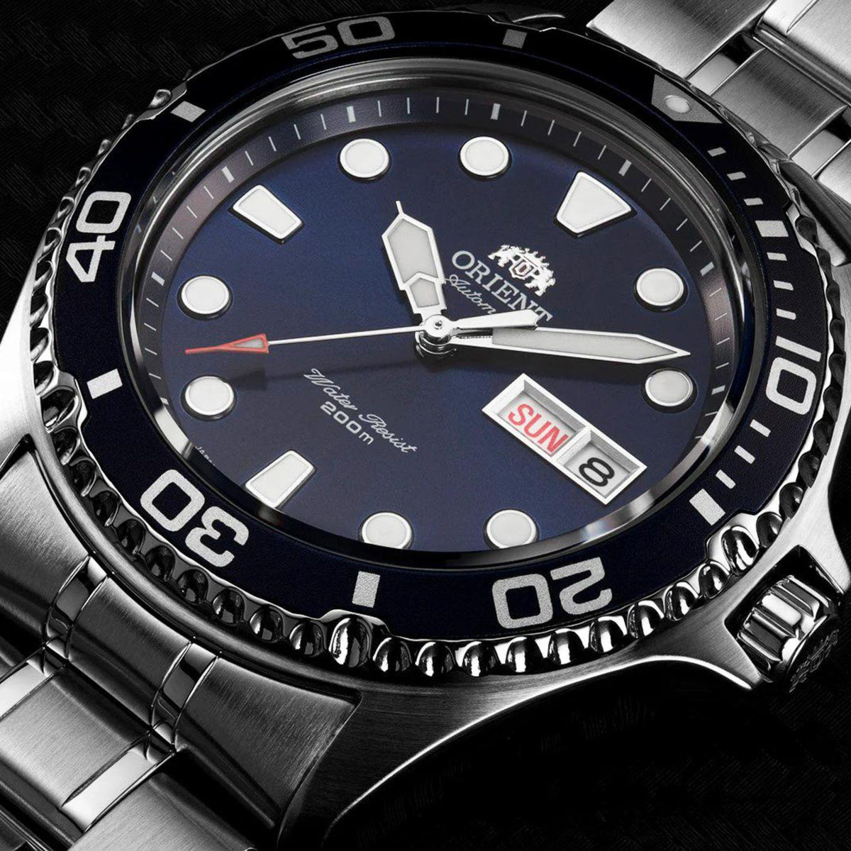 Men's Orient automatic watch close-up: blue dial with markers, hands, and date